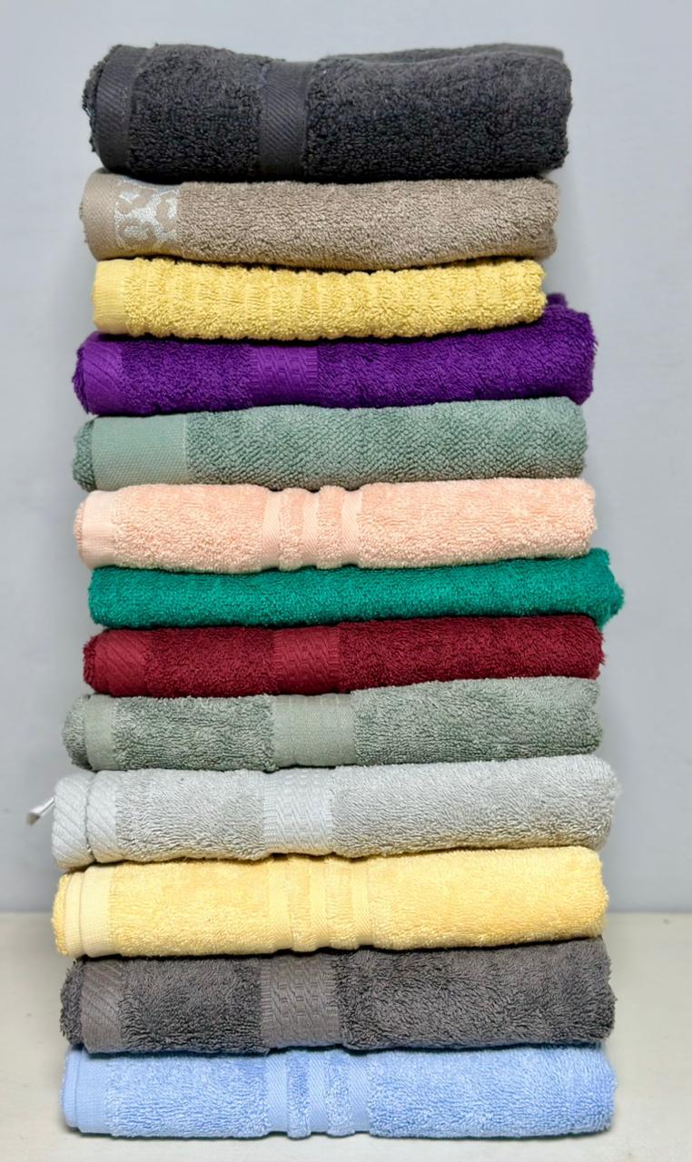 Real factory photo: folded hotel towel stack for hospitality bulk orders